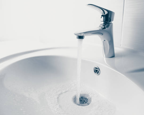 istock faucet and wash sink with flowing water 1018963386