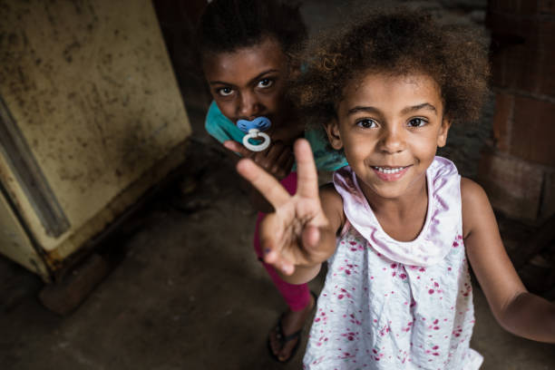 Brazilian little girl making two or V sign with her fingers stock photo