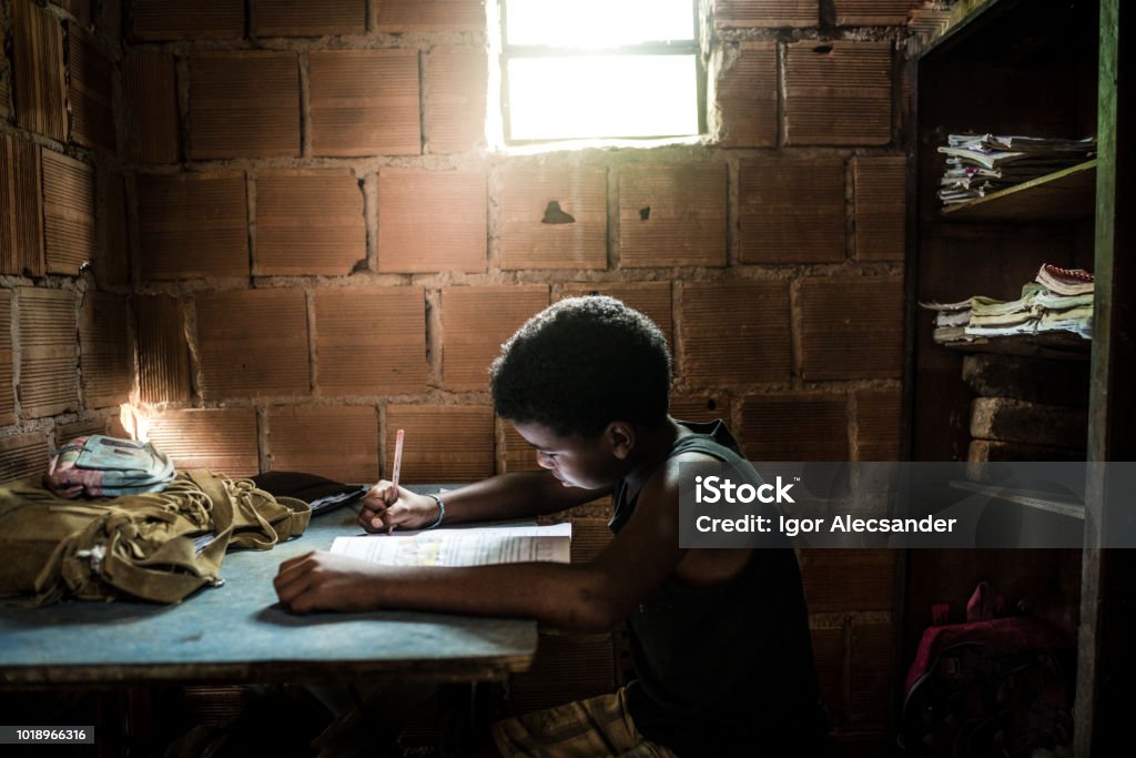 Brazilian boy studying at home Brazilian girl studying at home Poverty Stock Photo
