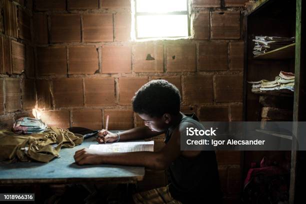 Brazilian Boy Studying At Home Stock Photo - Download Image Now - Poverty, Child, Brazil