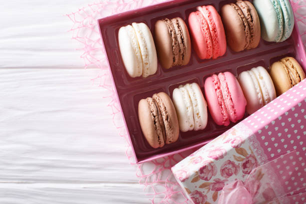 istock Beautiful macaroons in a pink gift box close-up on a table. Horizontal top view 1018969608