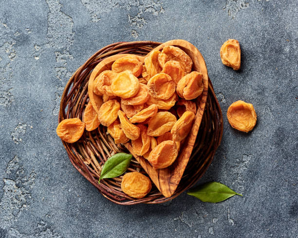 istock Dried apricots on gray concrete background. Top view. 1018969890