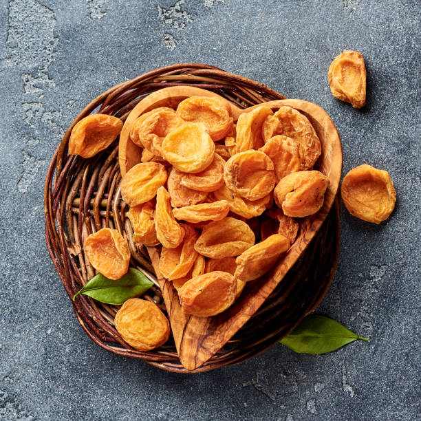 istock Dried apricots on gray concrete background. Top view. 1018969936
