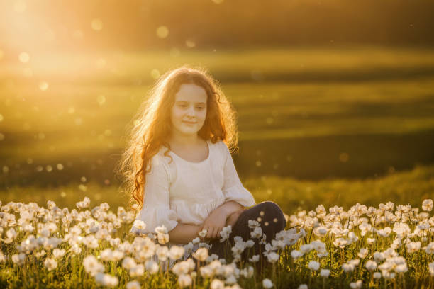 istock Curly baby resting on meadow outdoors. 1018978494