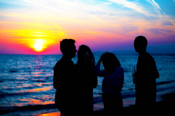 istock Young Adult Summer Beach Party Dancing Concept 1018987518