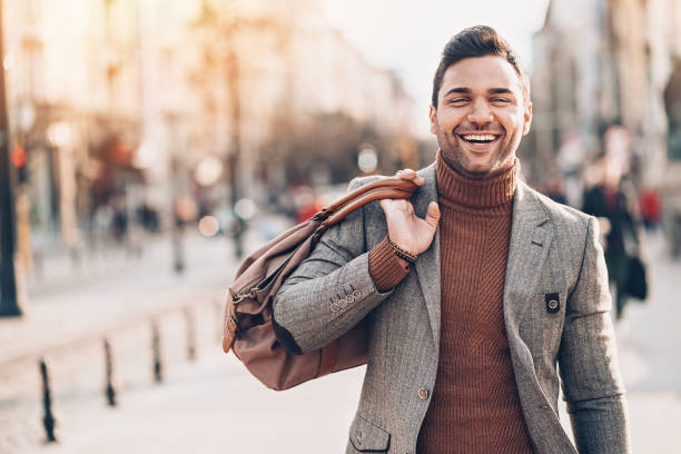 istock Smiling man with a bag on his shoulder 1018990930