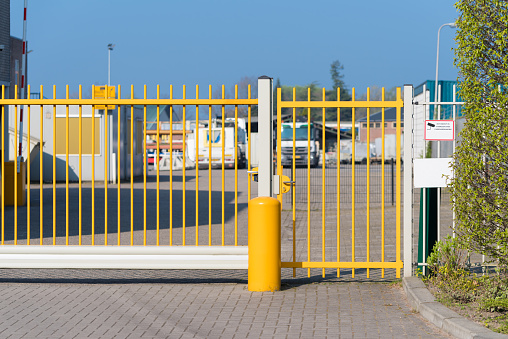 yellow automatic metal gate at an industrial area
