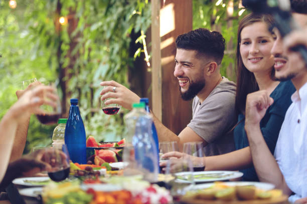 istock Multi-ethnic friends enjoying dinner together 1018994094