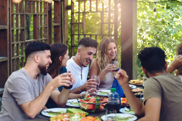 istock Multi-ethnic friends enjoying dinner together 1018994112