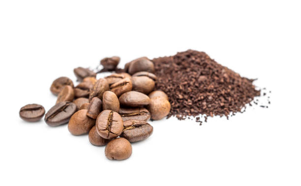 istock Pile of ground coffee and coffee beans on white. 1018996354