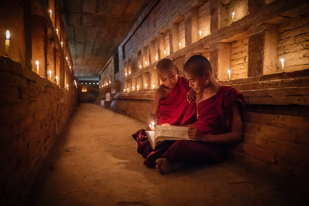 istock Burmese Novice Monks reading Buddhist Book inside Temple Bagan Myanmar 1019008736