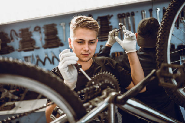 istock Two Mechanics Repairing Bicycles In Workshop 1019009216