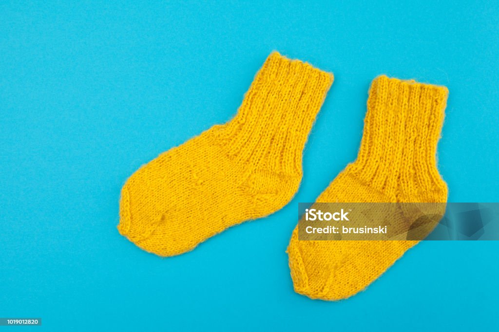 yellow socks on a blue background Sock Stock Photo