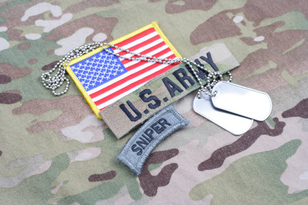 istock US ARMY sniper tab, flag patch,  with dog tag on camouflage uniform 1019025504
