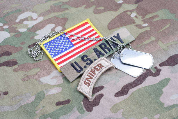 istock US ARMY sniper tab, flag patch,  with dog tag on camouflage uniform 1019025898