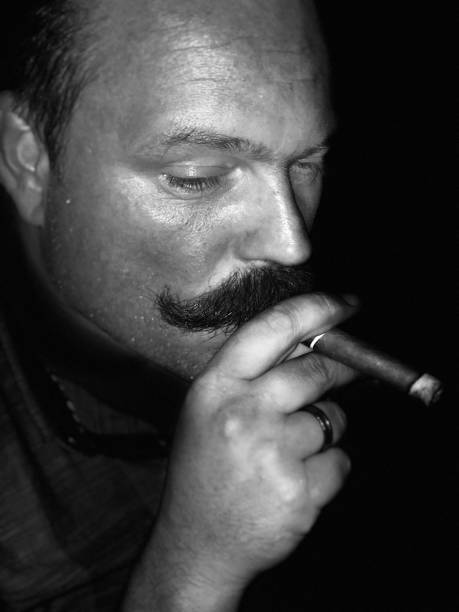 istock Man with big mustache and smoking a Cuban havana cigar 1019025948