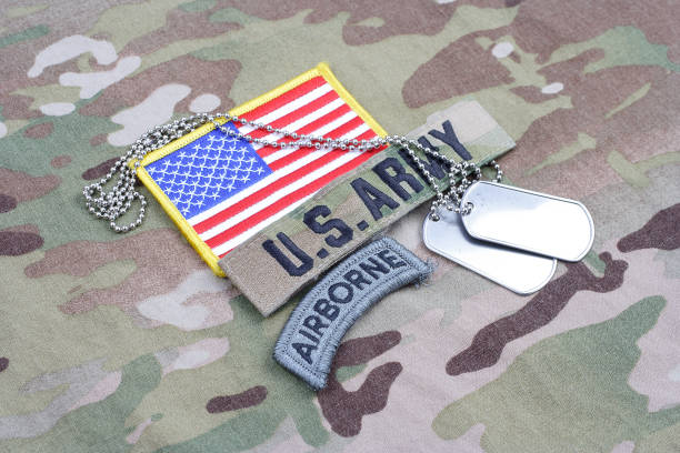istock US ARMY airborne tab, flag patch,  with dog tag on camouflage uniform 1019028480