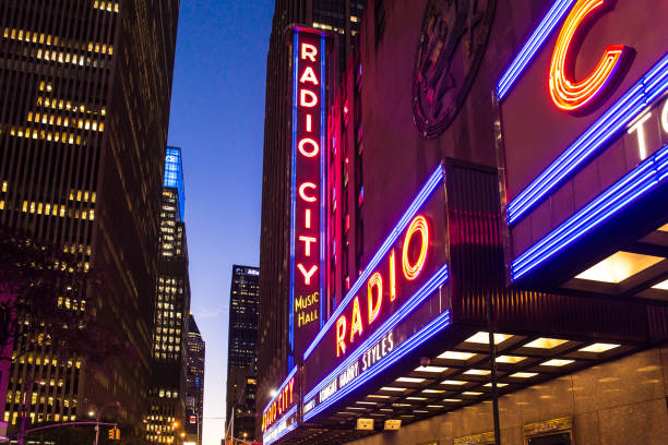 New York City, New York, USA - September 28, 2018: Bright lights of the Radio City Music Hall sign as seen at night from the sidewalk,