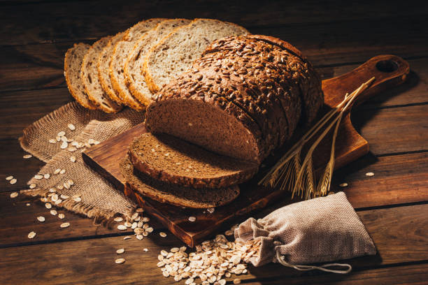 istock Rustic wooden table with rye bread and oats on top, rustic style 1019058498