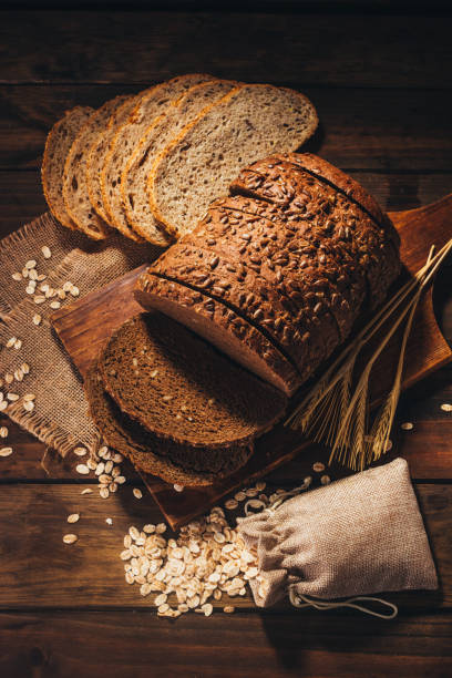 istock Top view of Rustic wooden table with rye bread and oats on top, rustic style 1019058564