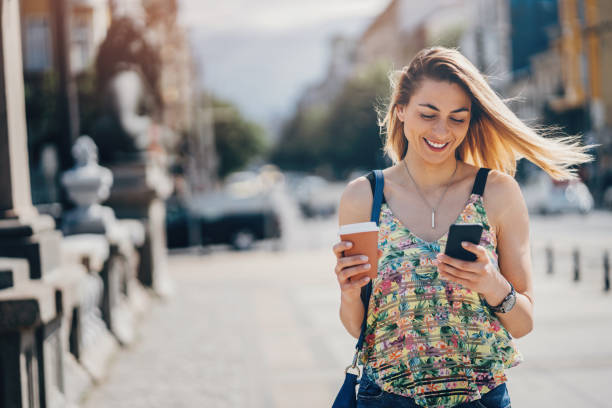 istock Happy woman walking and texting 1019058756