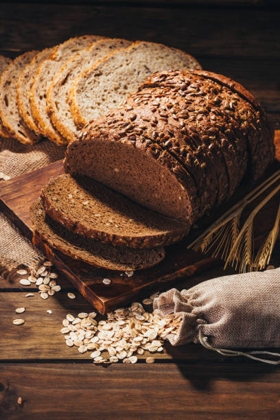 istock Rustic wooden table with rye bread and oats on top, rustic style 1019063168