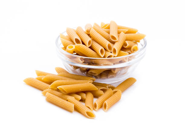 Container with wholemeal pasta isolated on a white background