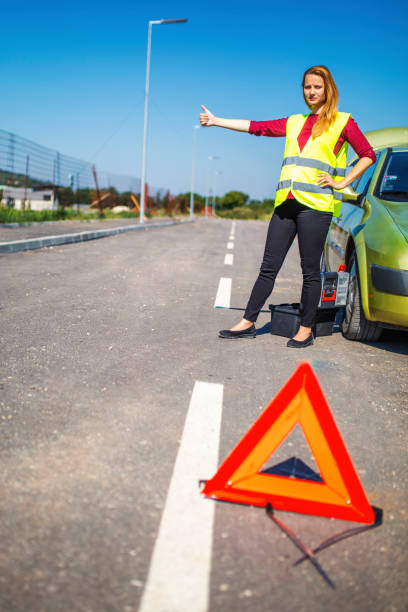 istock Young woman with her broken car 1019063540