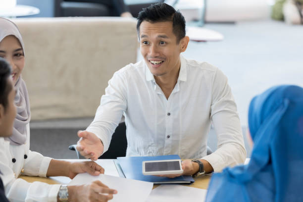 istock Mid adult manager talks with group of employees 1019065794