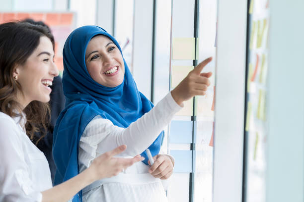 istock Cheerful businesswomen explore project ideas 1019065798