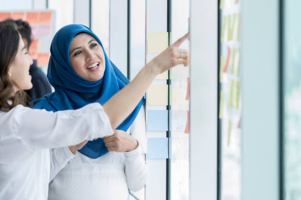 istock Cheerful diverse businesswomen discuss ideas 1019065806
