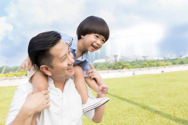 istock Cheerful dad carries son on shoulders 1019065974