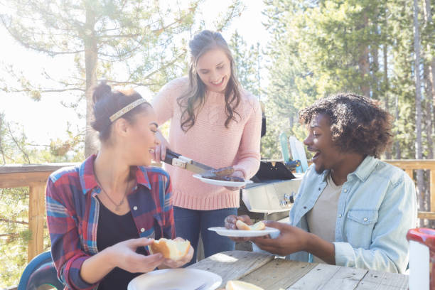 istock Young woman serves guests at a party 1019066028