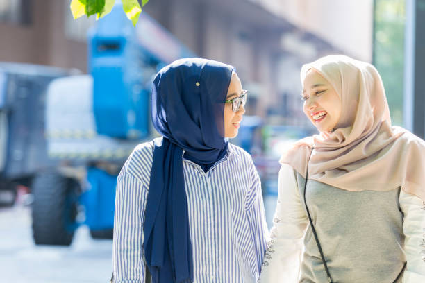 istock Malaysian sisters walk down busy street together 1019066200