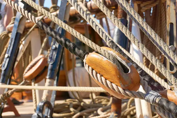 Close-up of a wooden rope pulley and ropes on an old sailingship