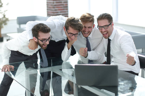 istock happy business team looking at the laptop screen 1019071588