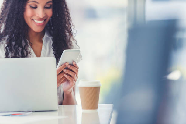 istock African American woman text messaging at her desk. 1019081806