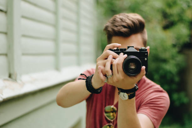 istock Hipster guy photographer with retro camera 1019082056