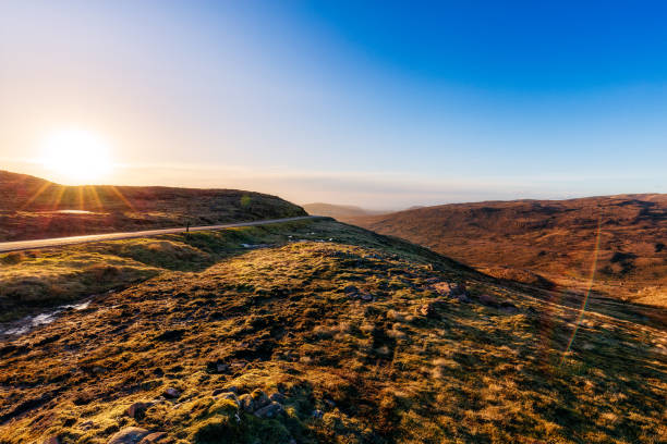 Bealach na Ba viewpoint with isle of Skye Bealach na Ba viewpoint with the isle of Skye in the background applecross peninsula stock pictures, royalty-free photos & images