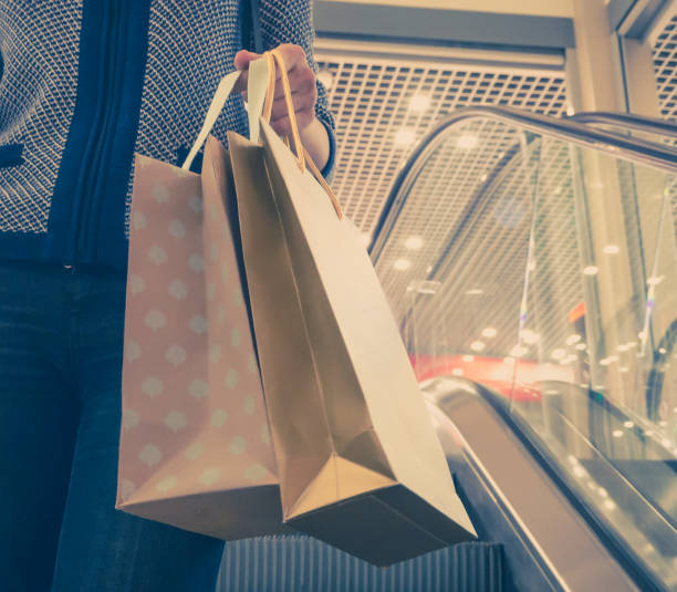 istock Woman with packages on the escalator. 1019103546