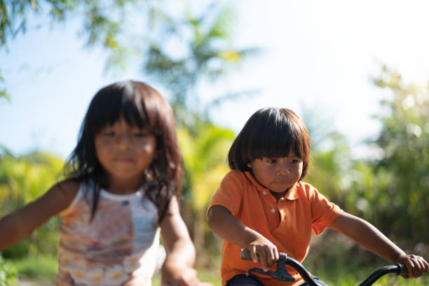 istock Siblings Riding a Bicycle in a Rural Place 1019103610