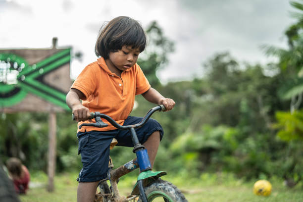 istock Cute Boy Riding a Bicycle in The Rural Place 1019106592