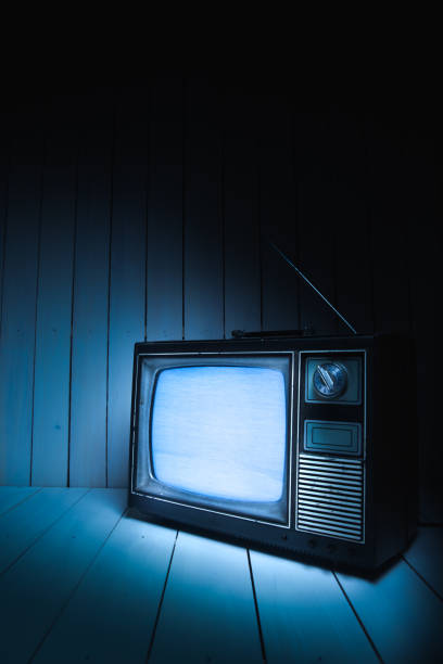 istock Vintage TV with static on white wooden background 1019106620