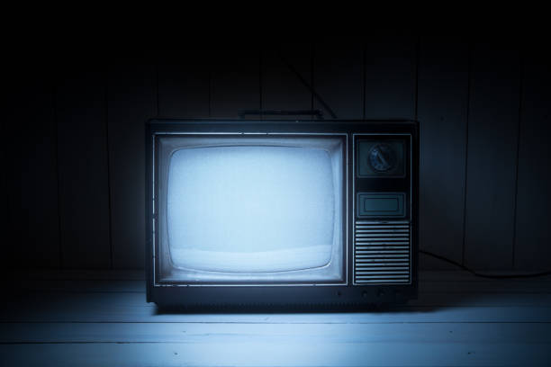 Vintage TV with static on white wooden background stock photo