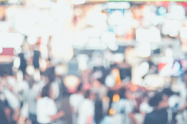 istock Blurred background,crowd of people in expo fair with bokeh light. 1019106928
