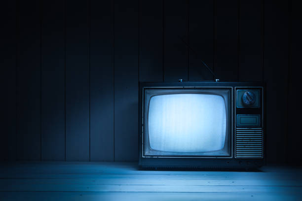 istock Vintage TV with static on white wooden background 1019109722