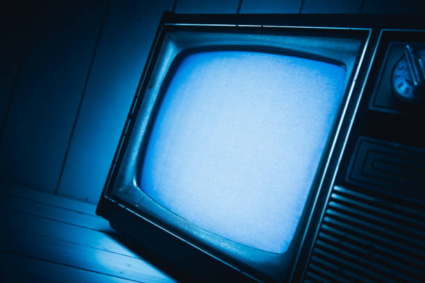 istock Vintage TV with static on white wooden background 1019109776