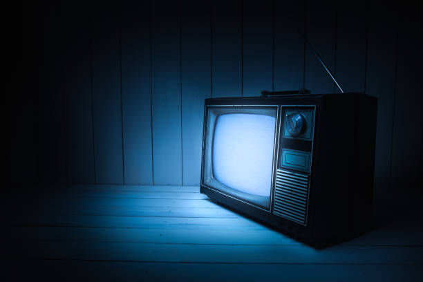 istock Vintage TV with static on white wooden background 1019110506