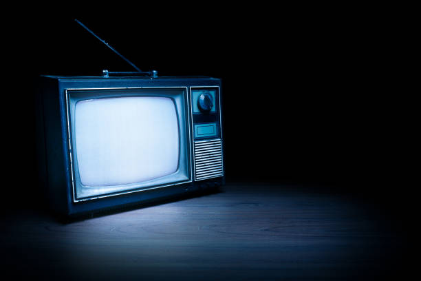 istock Vintage TV with static on white wooden background 1019110802