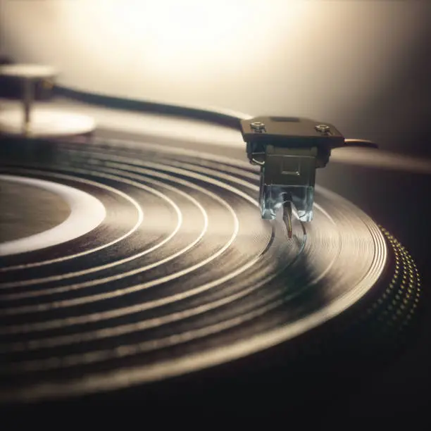 Vinyl record being played on old retro vintage disc jockey device.